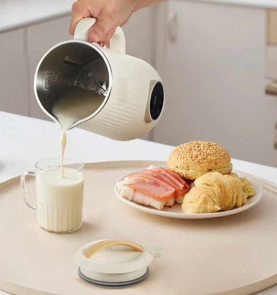 Pouring fresh plant milk from the Milkly maker